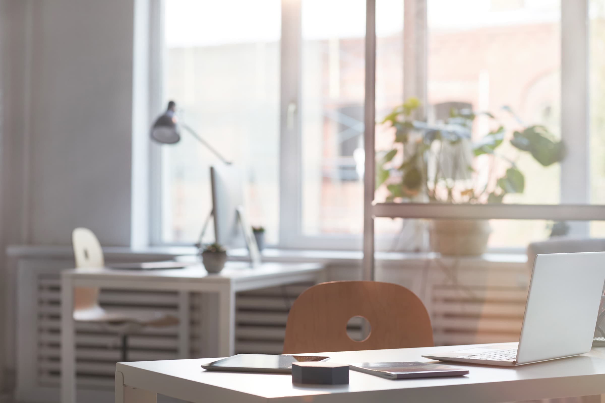 A quiet office with a desk and chair in natural light